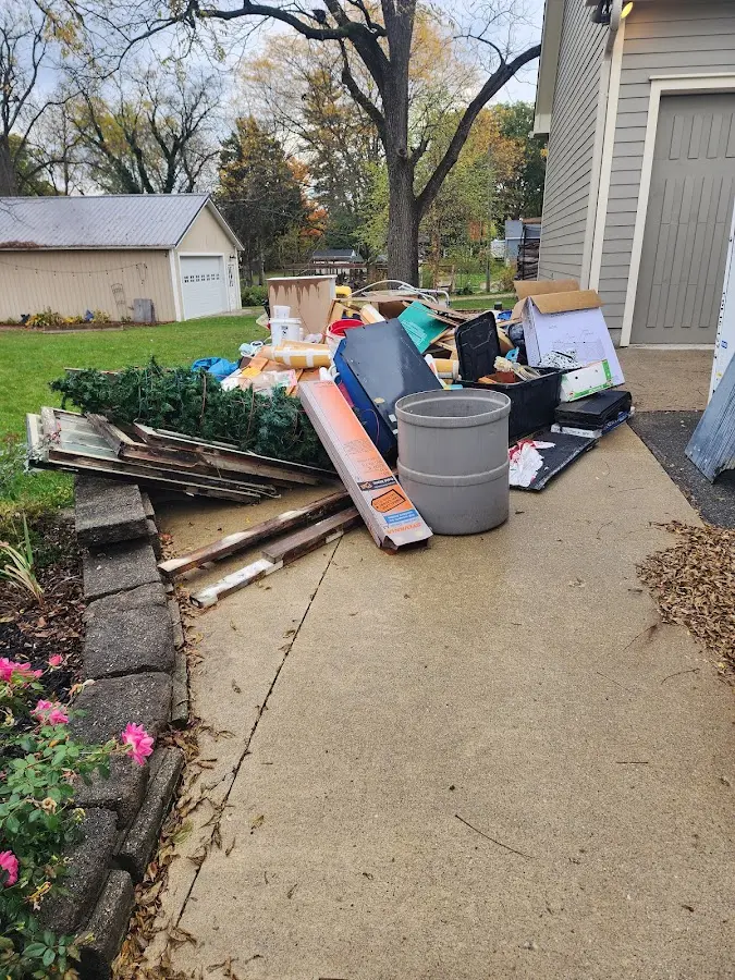 Dumpster being loaded with debris for 30 Yard Dumpster Rental in Portage